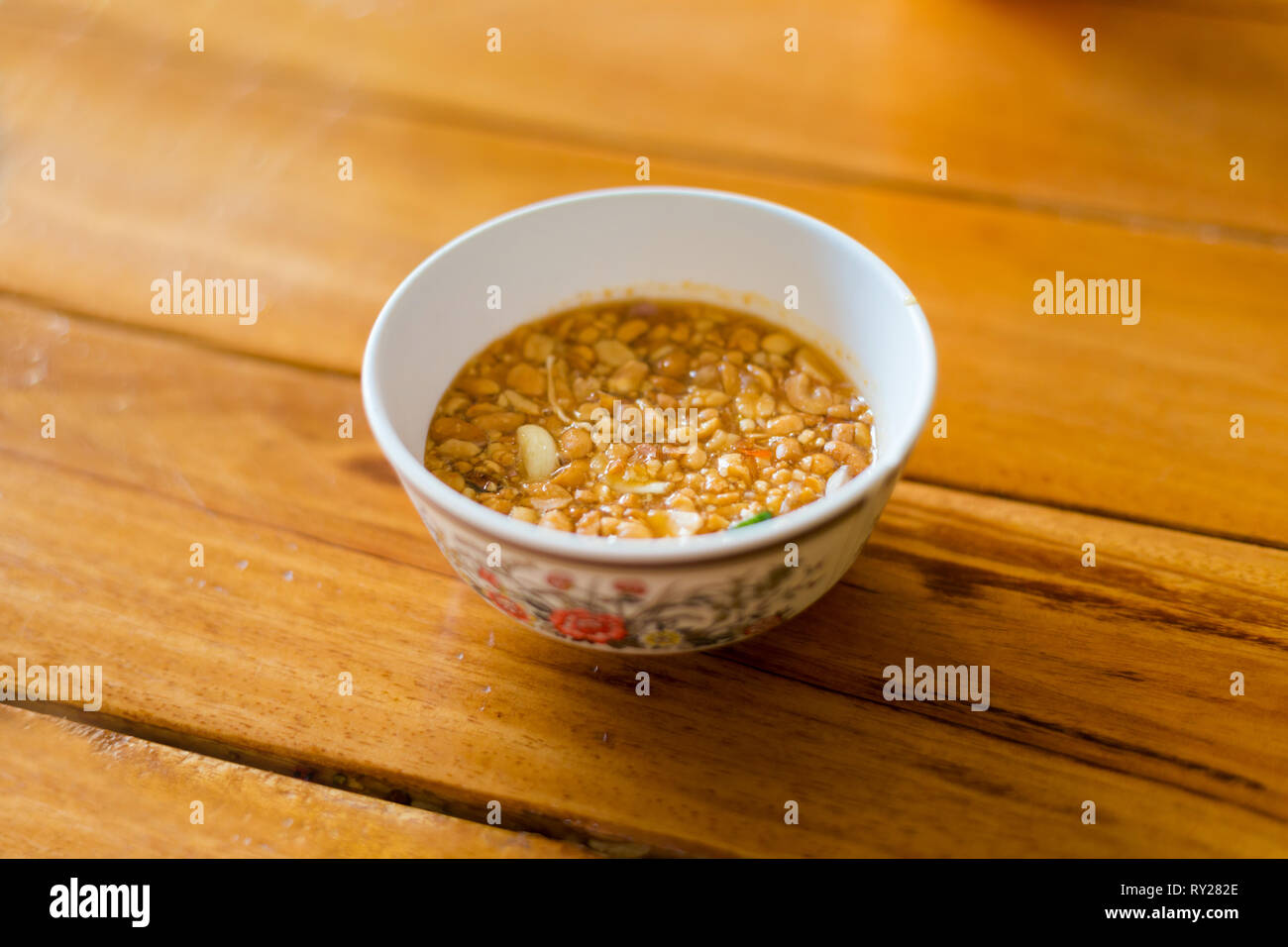 Fresh prepared asian sweet and spicy satay sauce made of chopped peanuts. Traditional thai