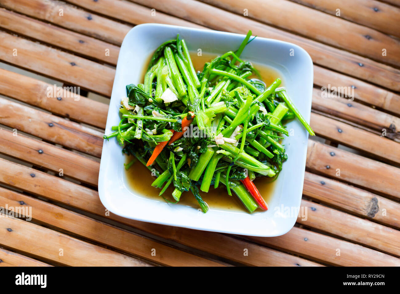 Thai fried morning glory with bird eye chilli and garlic. Traditional
