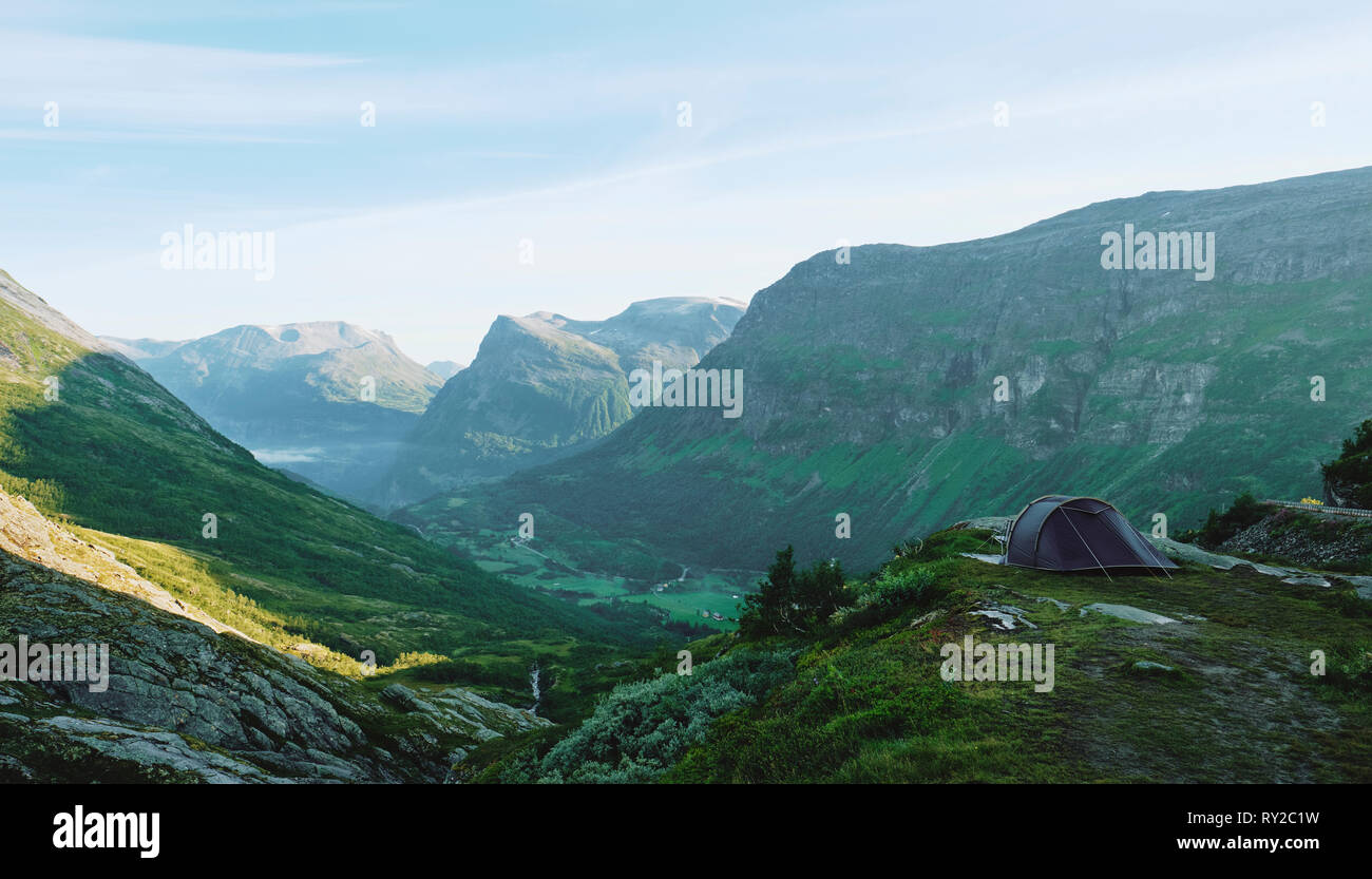 A lone tent wild camping in the early morning summer mountain landscape of Norway. Stock Photo