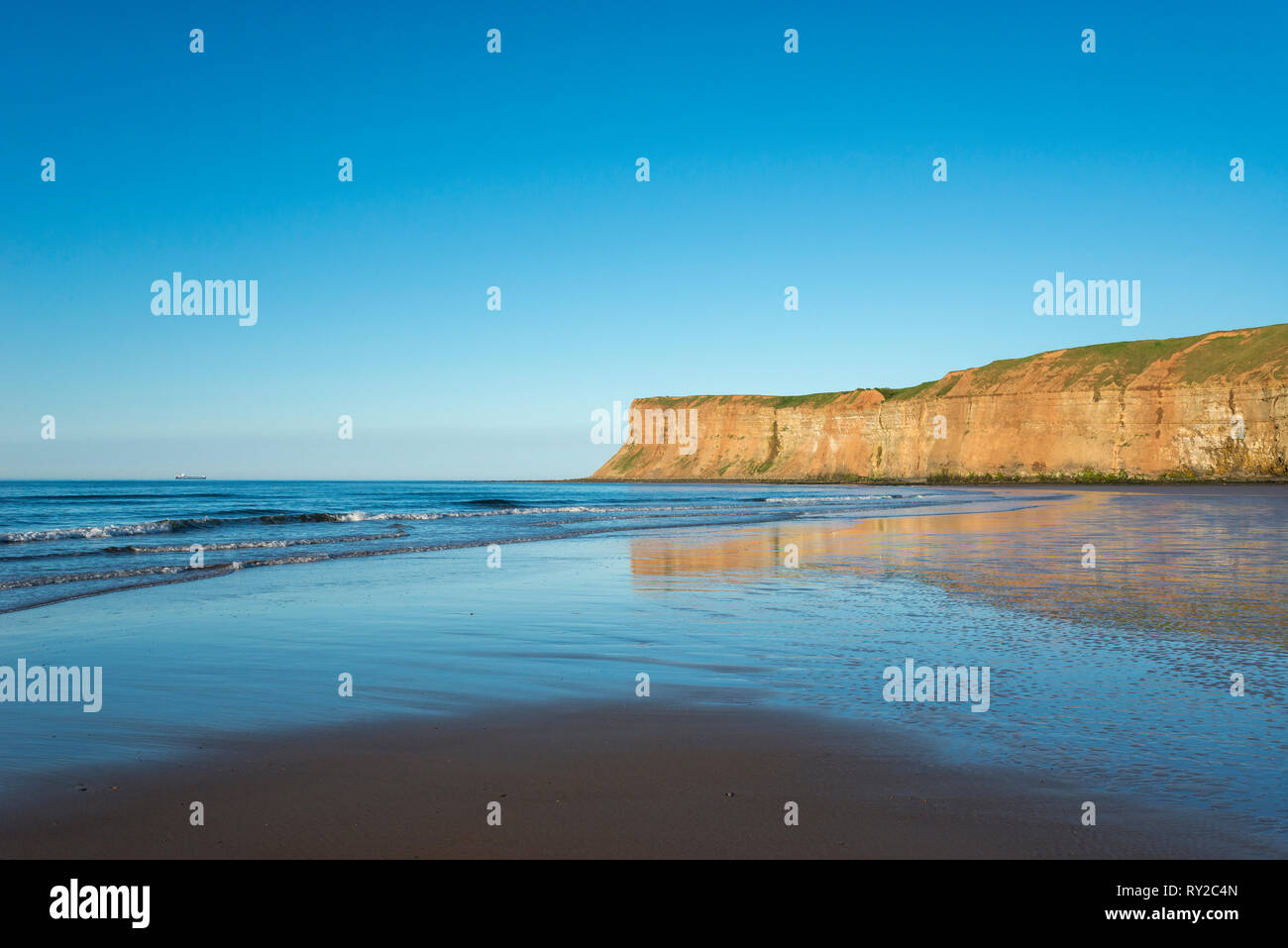 Beautiful beach at Saltburn-by-the-sea on the coast of North Yorkshire, England. View to the high cliffs of Huntcliff. Stock Photo