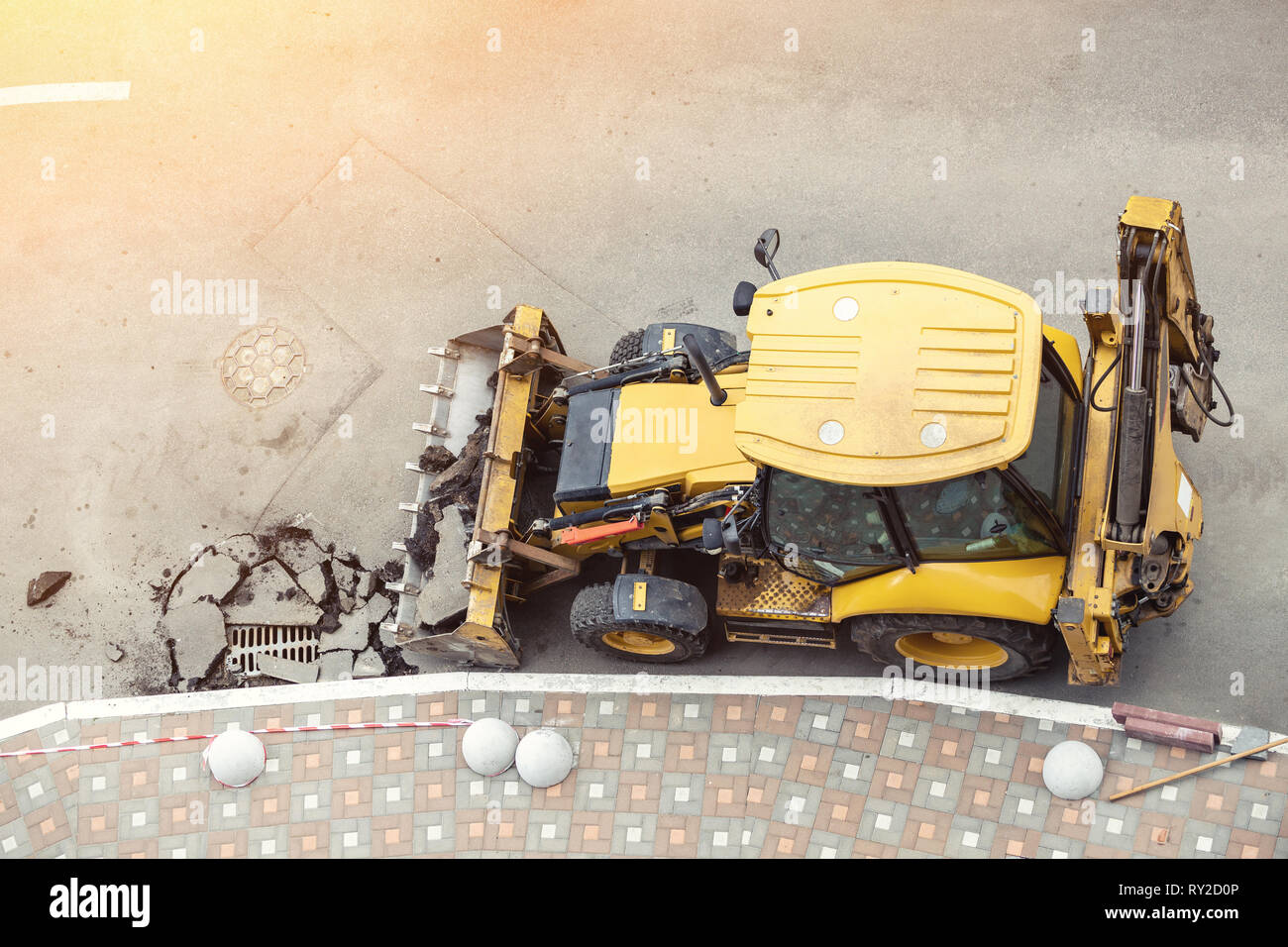 Big jackhammer drill drilling road.Heavy machinery crushing asphalt for