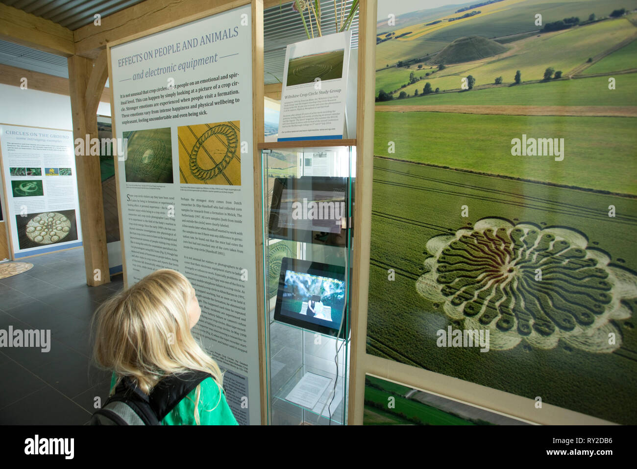 Great Britain, Wiltshire.  Young girl reading a display at a Crop circle exhibition (2017) -  a famous global phenomenon. MR. Stock Photo