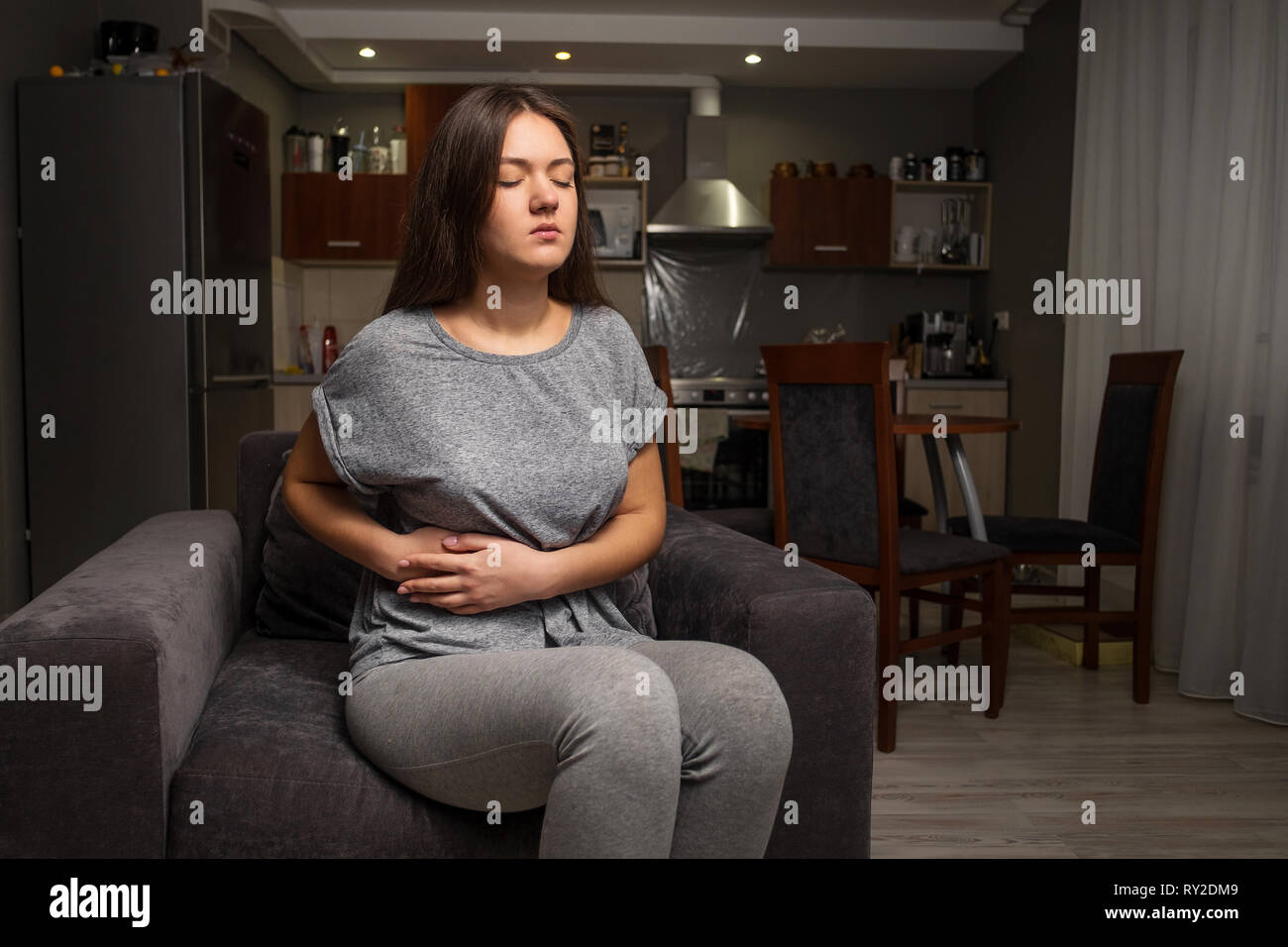 young woman has pain in right hypochondrium, stomachache, gallbladder disease Stock Photo