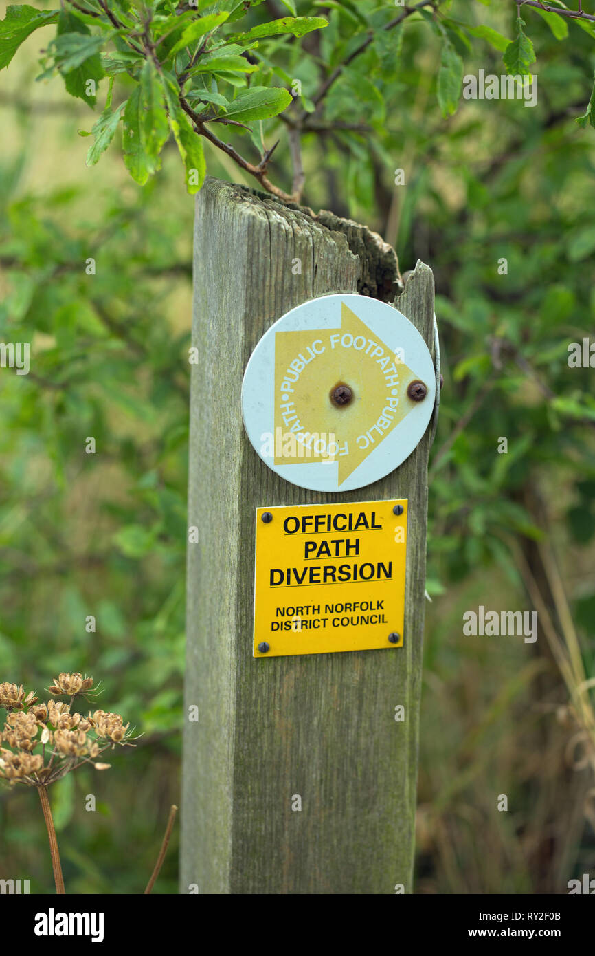 Sign on a wayside post. Public Footpath on a directional arrow. Below additional wording, OFFICIAL PATH DIVERSION, NORTH NORFOLK DISTRICT COUNCIL.  Stock Photo