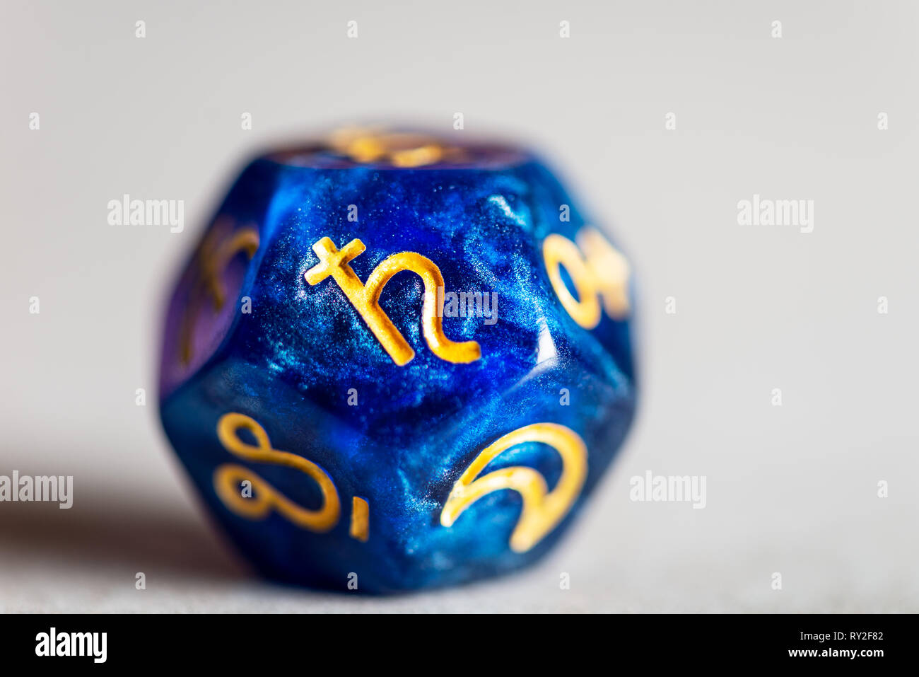 Astrology Dice with symbol of the planet Saturn Stock Photo