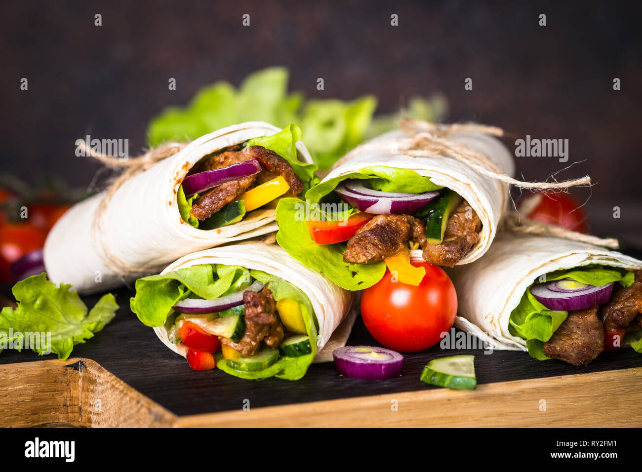 Burritos tortilla wraps with beef and vegetables Stock Photo - Alamy