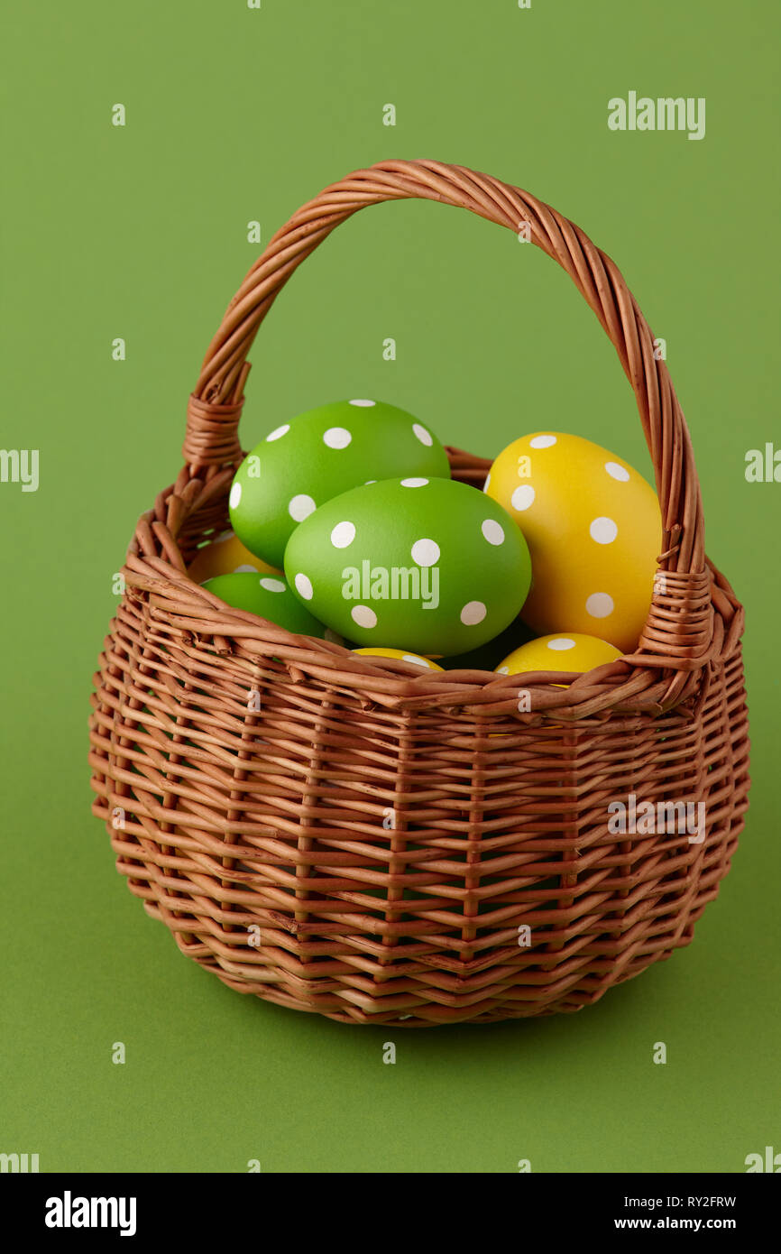 Wicker basket with painted Easter eggs Stock Photo - Alamy