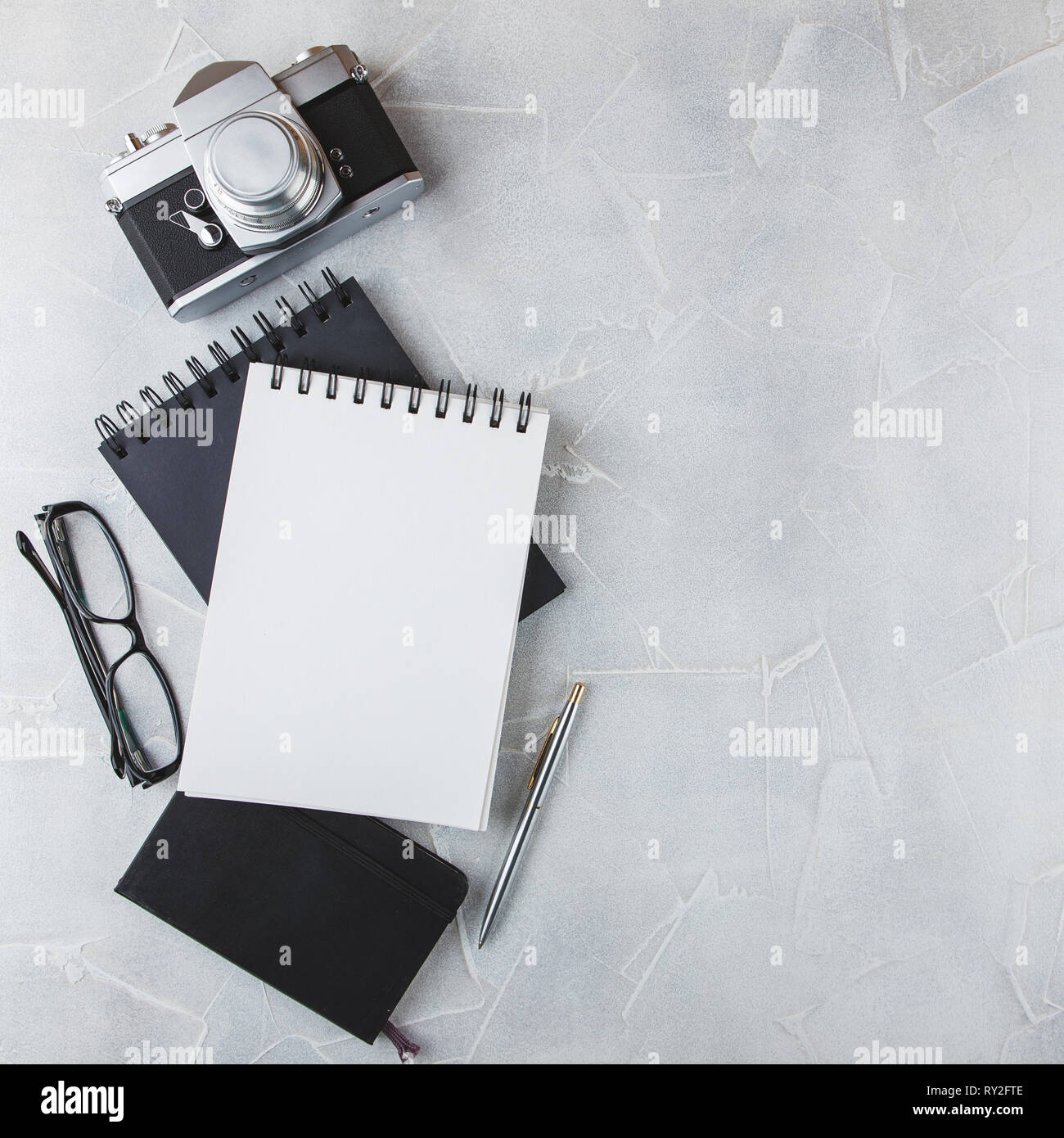 Retro photo film camera with note books, pen on light background Stock ...