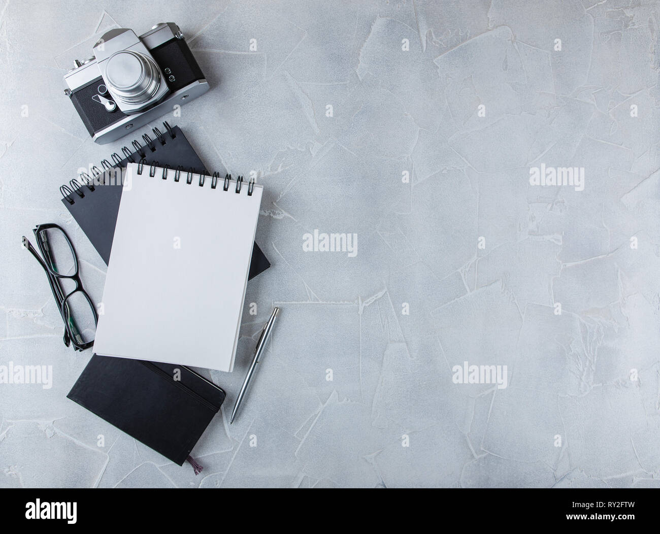 Retro photo film camera with note books, pen on light background Stock ...