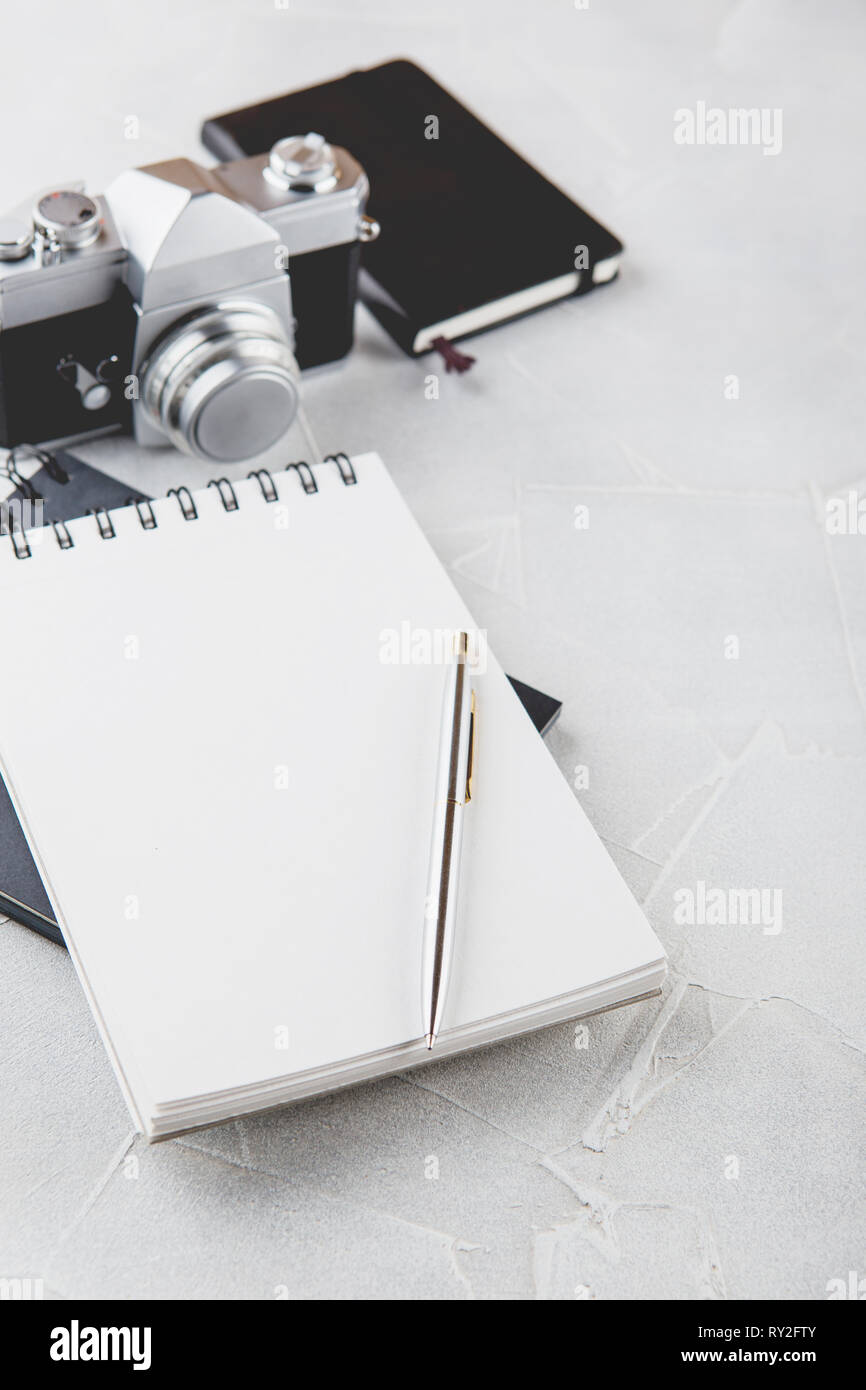 Retro photo film camera with note books, pen on light background Stock ...