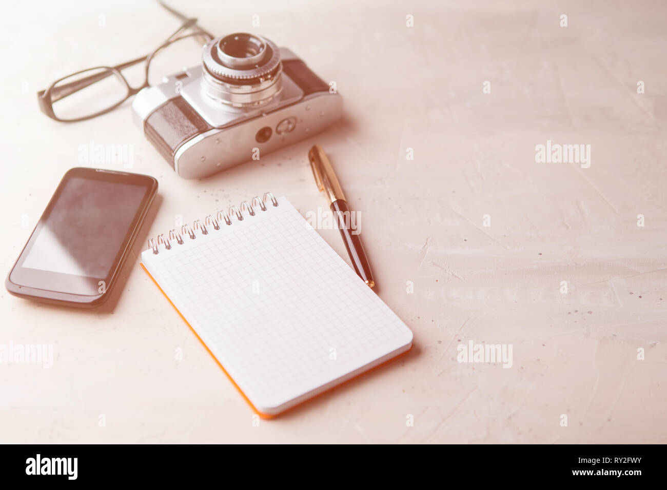 Retro photo film camera with note books, pen on light background Stock ...