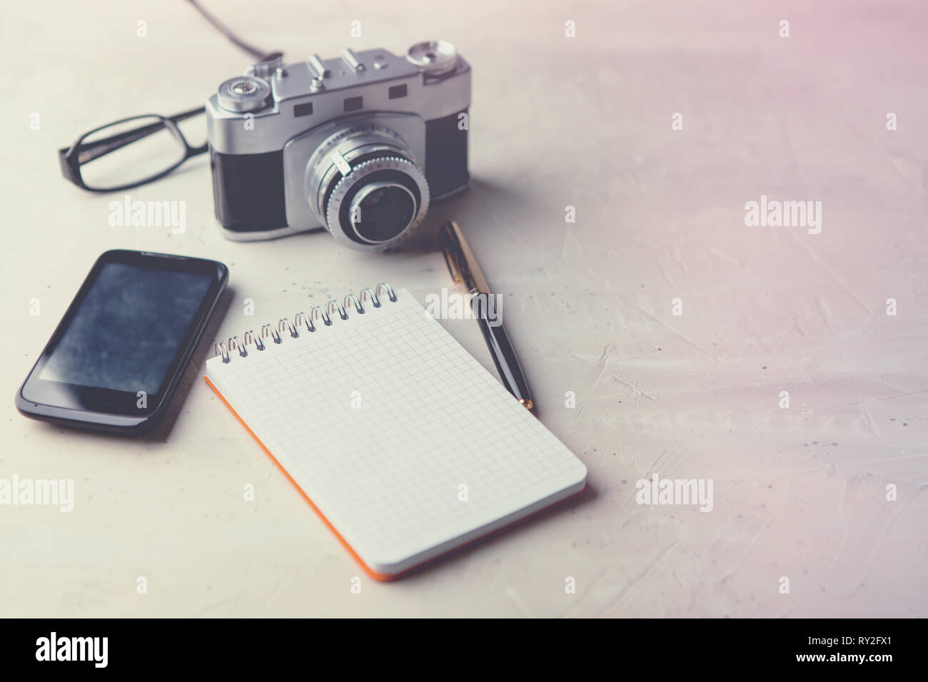 Retro photo film camera with note books, pen on light background Stock ...