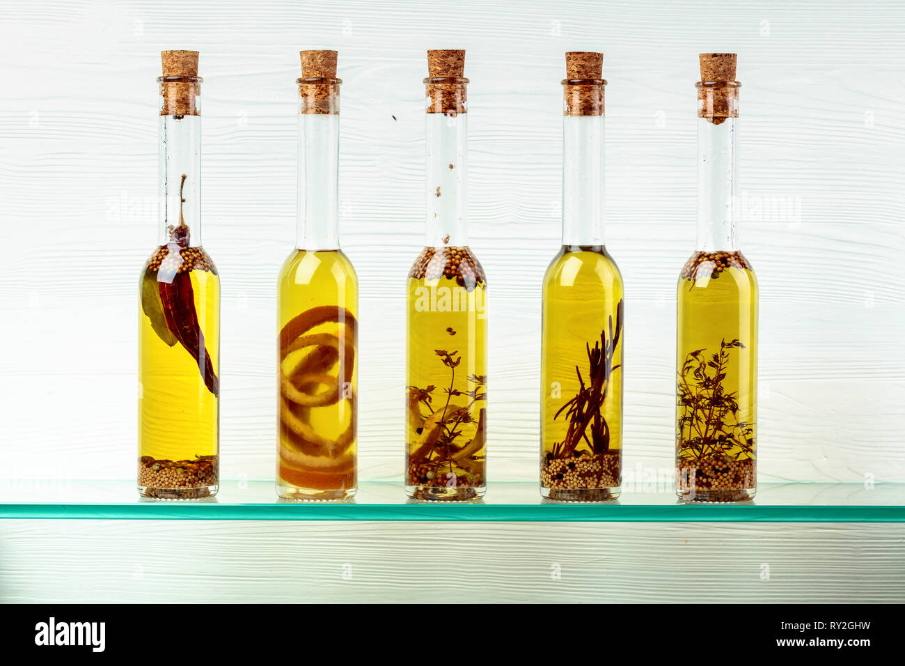 Small bottles of olive oil with herbs and spices Stock Photo - Alamy