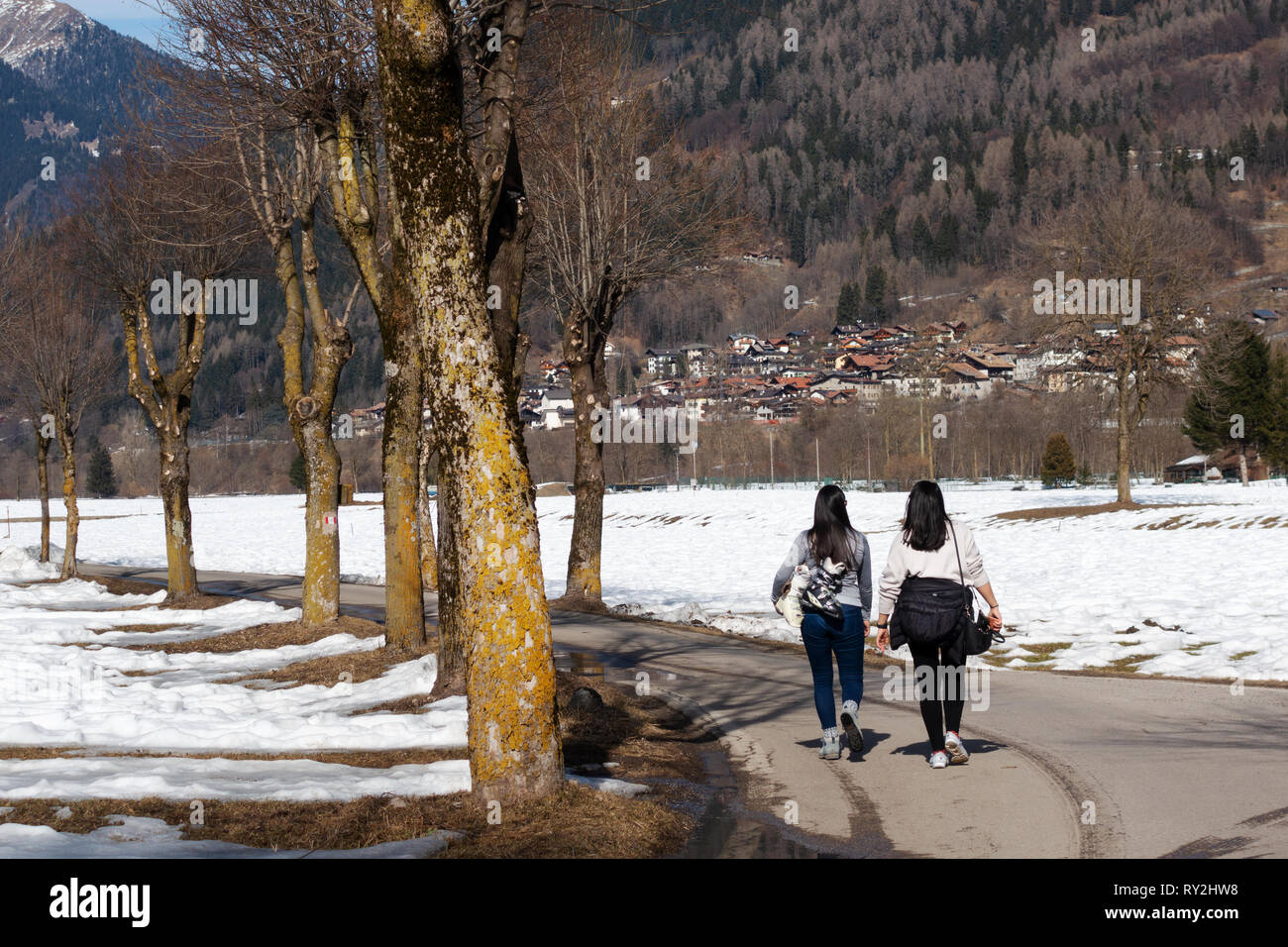 Two women walking to the village of Pinzolo in the Brenta Dolomites, northern Italy Europe Stock Photo