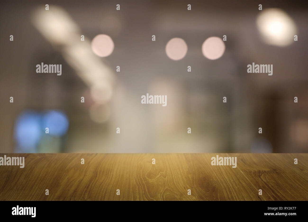 Empty wooden table in front of abstract blurred background of ...