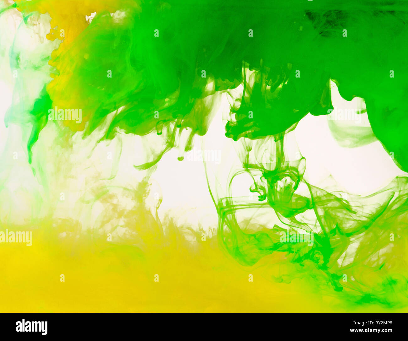 Colored paint swirling in water Stock Photo