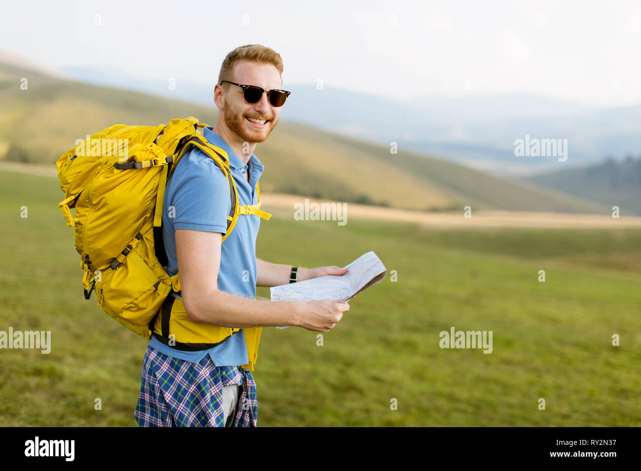 Handsome hiker holding map mountain hi-res stock photography and images ...