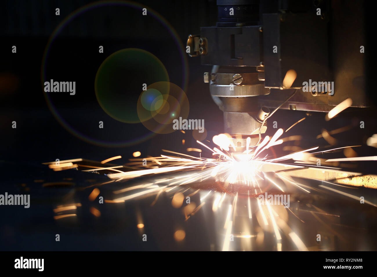 Sparks fly out machine head for metal processing Stock Photo