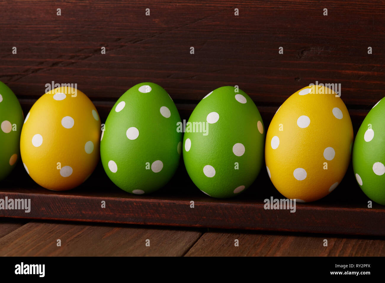Dotted Easter eggs on wooden background Stock Photo