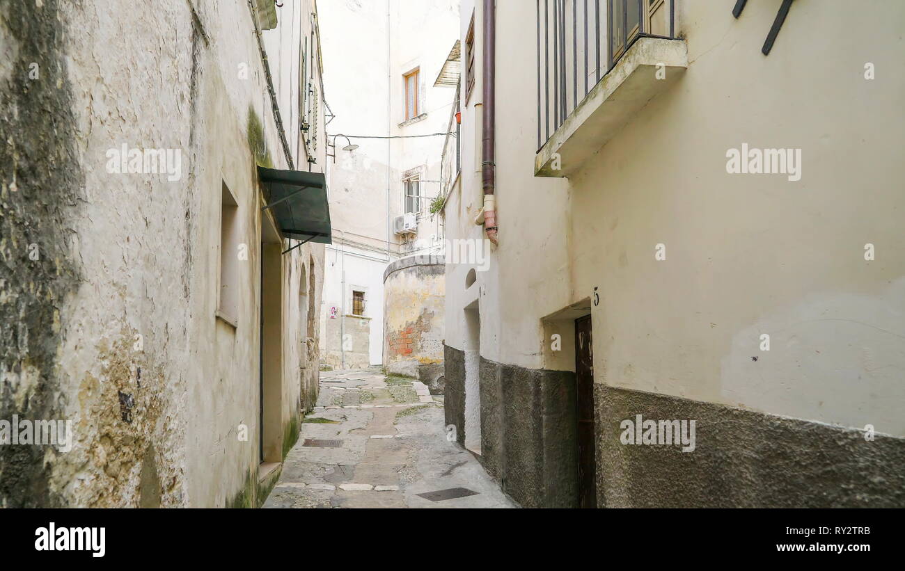 The narrow street of the Rodi Italy with the white houses on the side Stock Photo