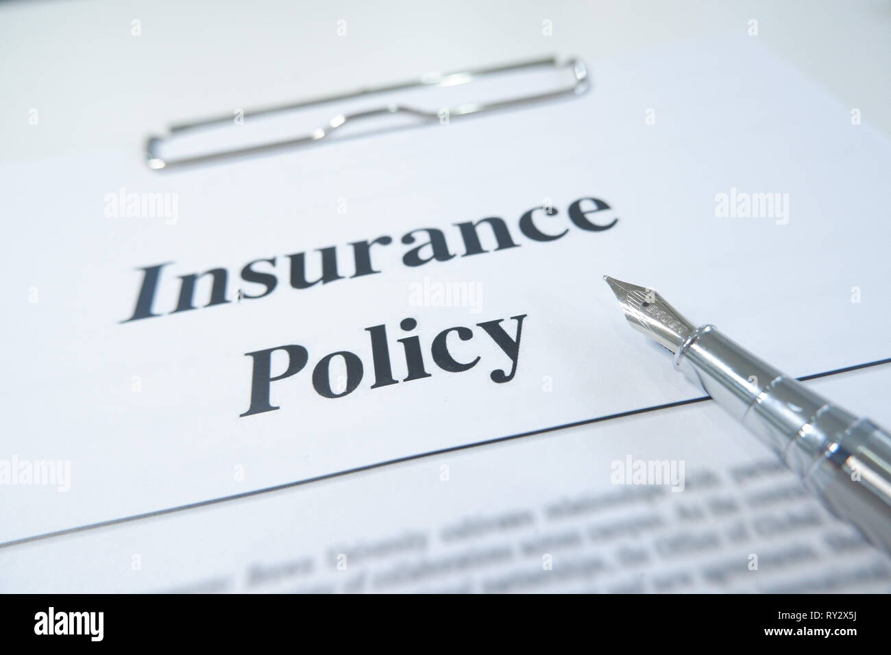 Insurance Policy Form And Pen On Desk In Office Showing Risk