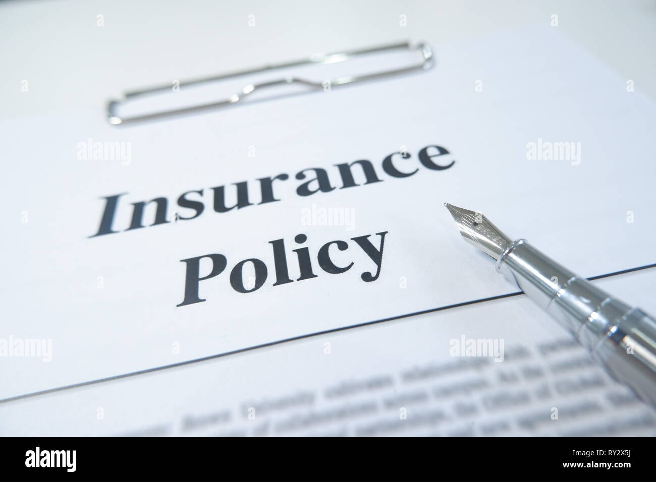 insurance policy form and pen on desk in office showing risk concept. Life; Health, car, travel insurance concept. Stock Photo