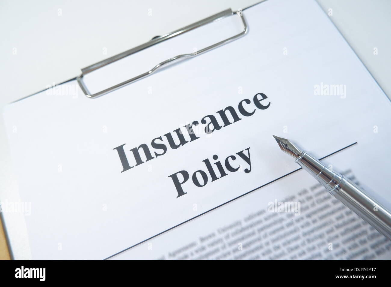 insurance policy form and pen on desk in office showing risk concept. Life; Health, car, travel Stock Photo