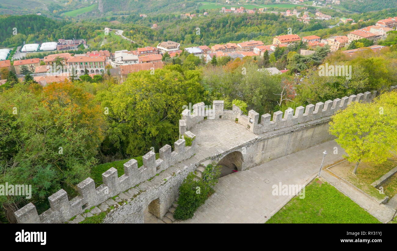 An arch wall of the Montale tower and the trees on the back from the mountain slope Stock Photo