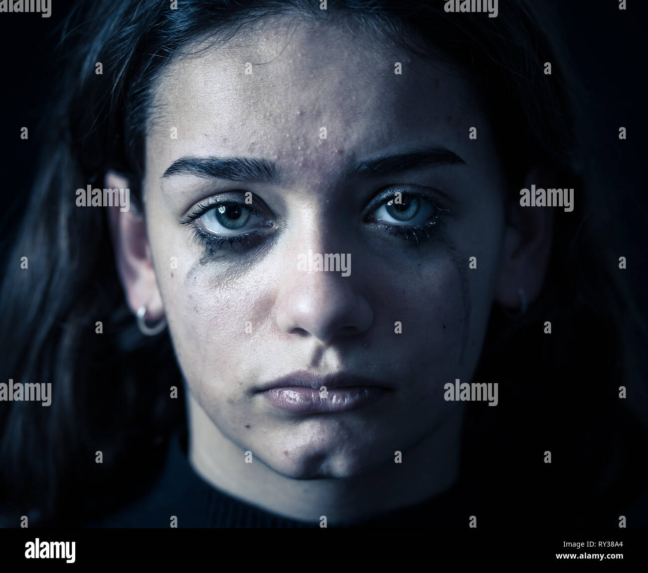 Scared upset girl bullied online suffering harassment crying feeling desperate and intimidated. Child victim of cyberbullying, stalker, social media a Stock Photo