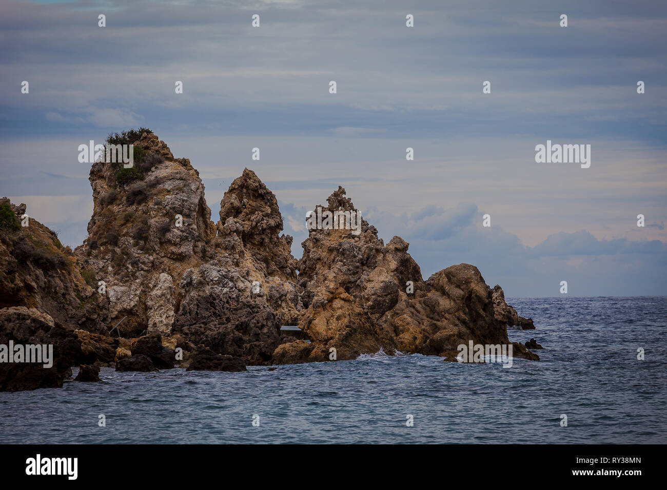Rocks of bizarre shapes in Paleokastritsa bay on a rainy day, Corfu Island, Greece Stock Photo