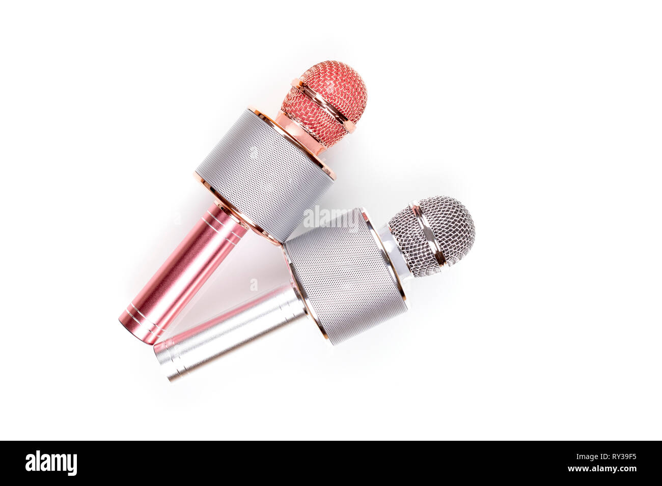 Two microphones isolated over white background . Two wireless microphones for karaoke or entertainment. - Image Stock Photo