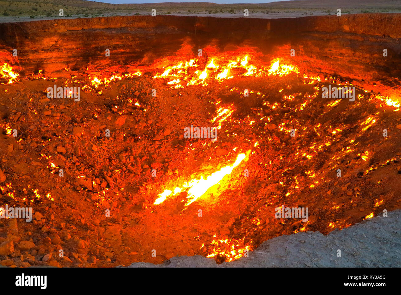 Darvaza Gas Crater Pit Breathtaking Flames Close Up at Sunrise Stock Photo
