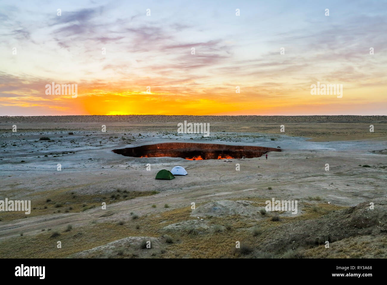 Darvaza Gas Crater Pit Breathtaking Two Tents at Sunrise Stock Photo