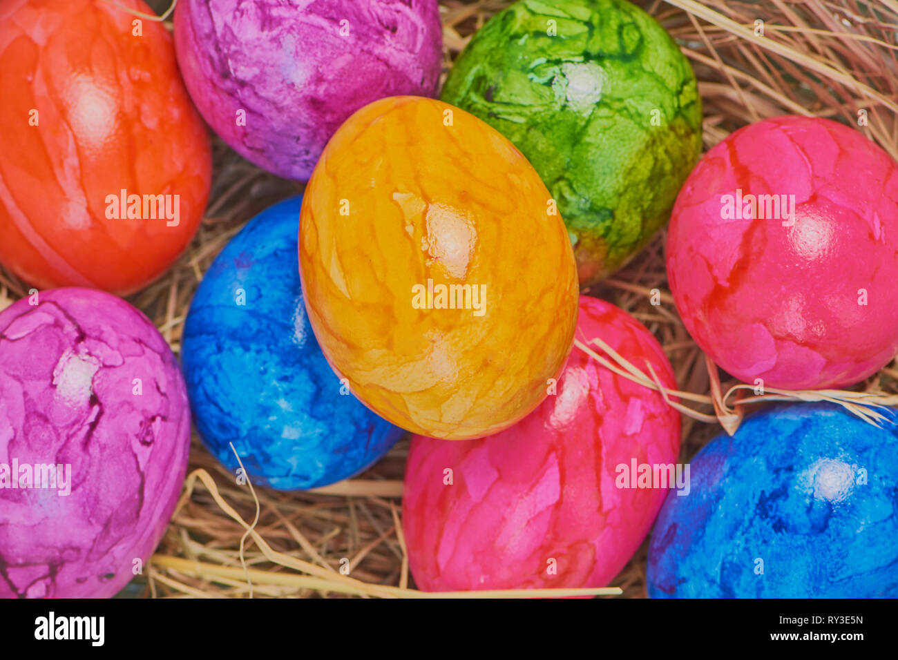 colored easter eggs in an easter basket, close up macro color photo Stock Photo