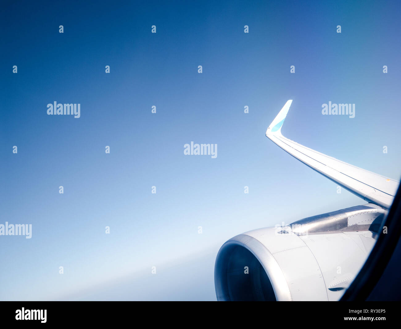 View from window of plane turbine in flight high above clouds high altitude travel security safety flight Stock Photo
