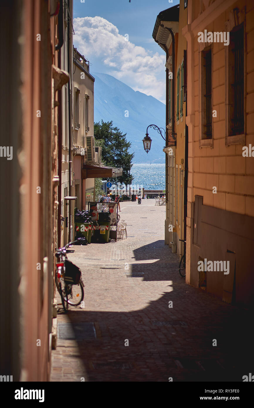 Riva del Garda, Italy - August, 2018. A narrow street in the historical centre of the town. Stock Photo