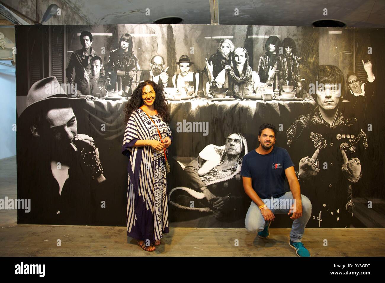 Cuba, La Havana, Vedado, couple managing the multicultural center la Fabrica de arte cubano in front of a contemporary work of Marice Renoma exhibited in the industrial setting of this old oil factory Stock Photo