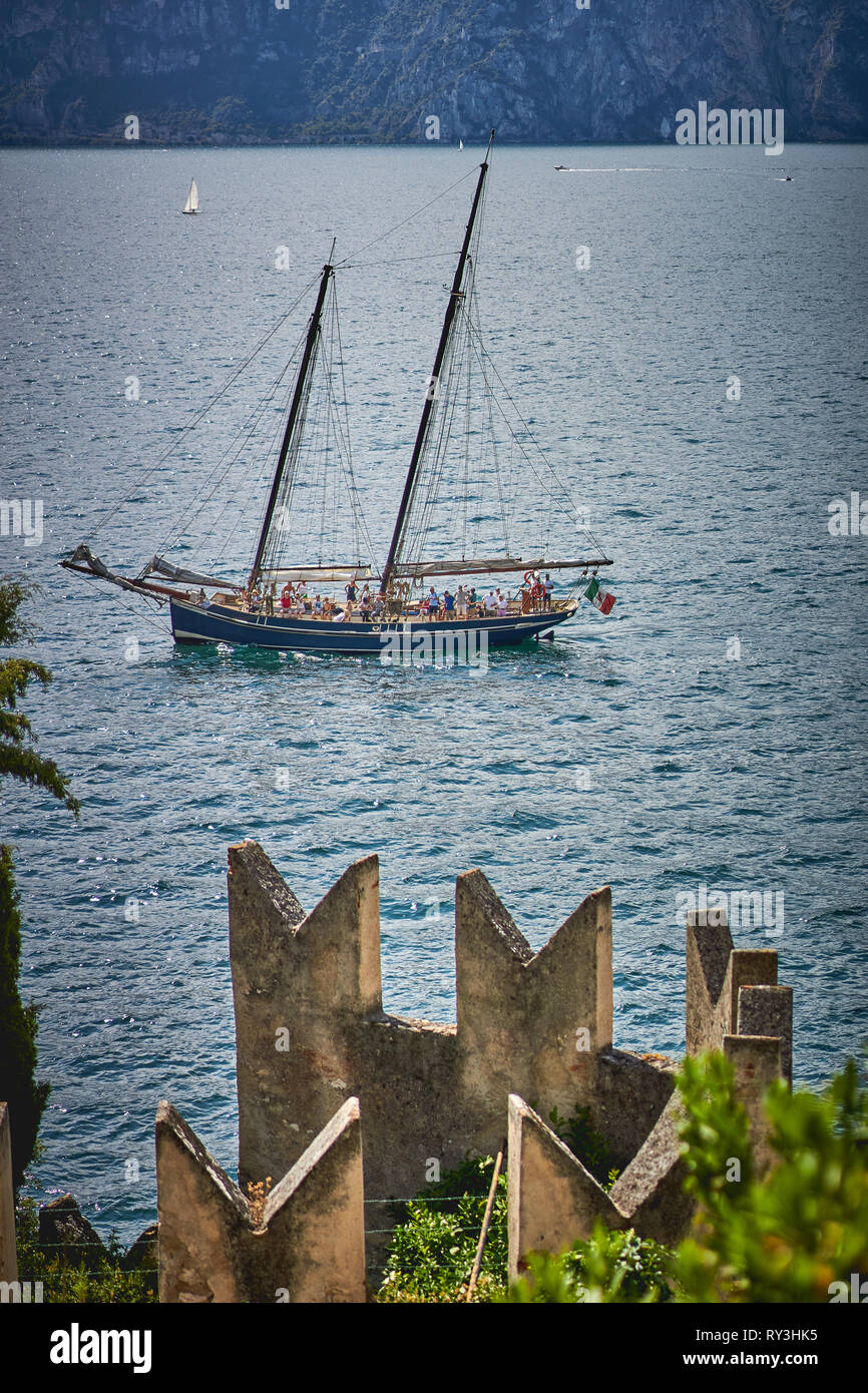 Malcesine, Italy - August, 2018. A sailboat on the lake Garda, the biggest Italian lake, near the town of Malcesine. Stock Photo