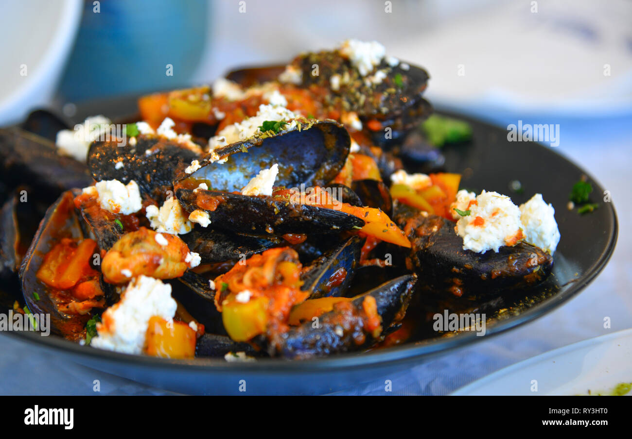 Traditional Greek mussels with goat cheese at local restaurant. Stock Photo