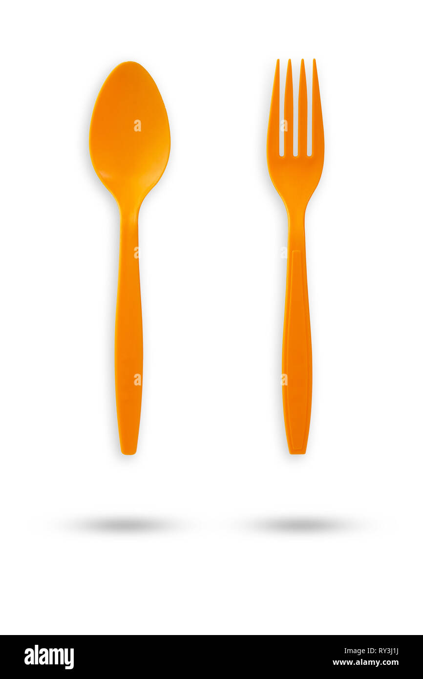 Orange plastic fork and spoon on isolate white background with clipping path. Stock Photo