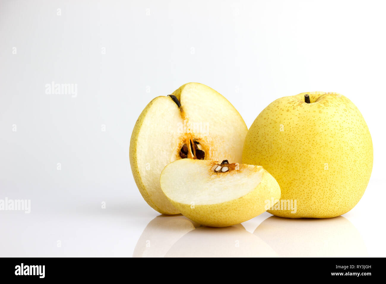 Chinese pear and reflection on white background. Healthy fruit. Stock Photo