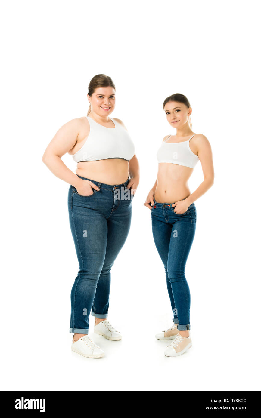 smiling overweight and slim women in jeans posing with hands in pockets isolated on white body positivity concept Stock Photo Alamy