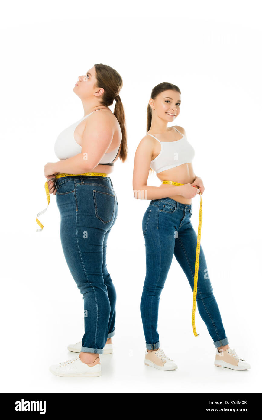 sad overweight woman with measuring tape looking upwards while attractive slim  woman looking at camera isolated on white Stock Photo - Alamy