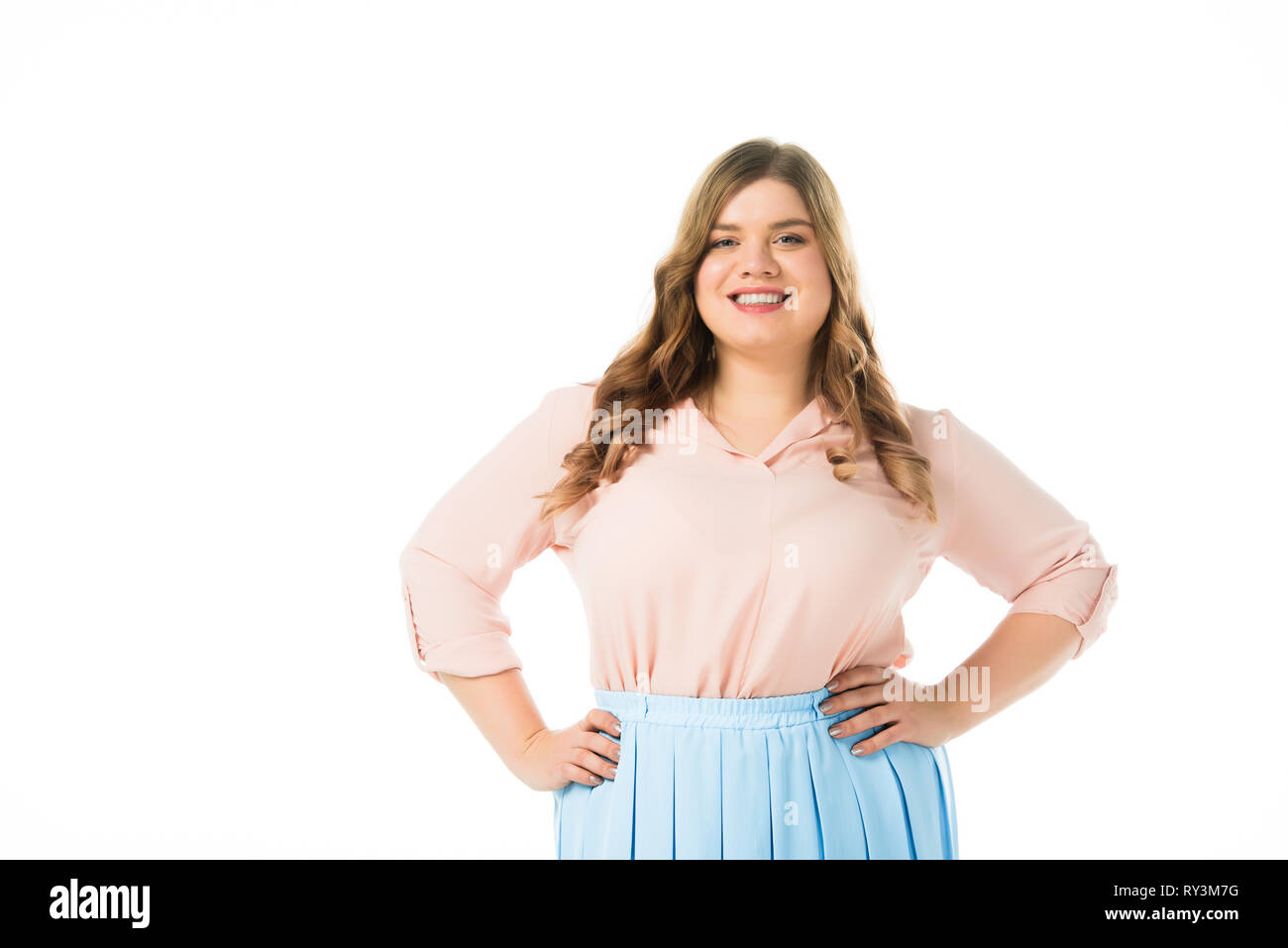 smiling happy plus size woman posing with hands on hips isolated on white  Stock Photo - Alamy