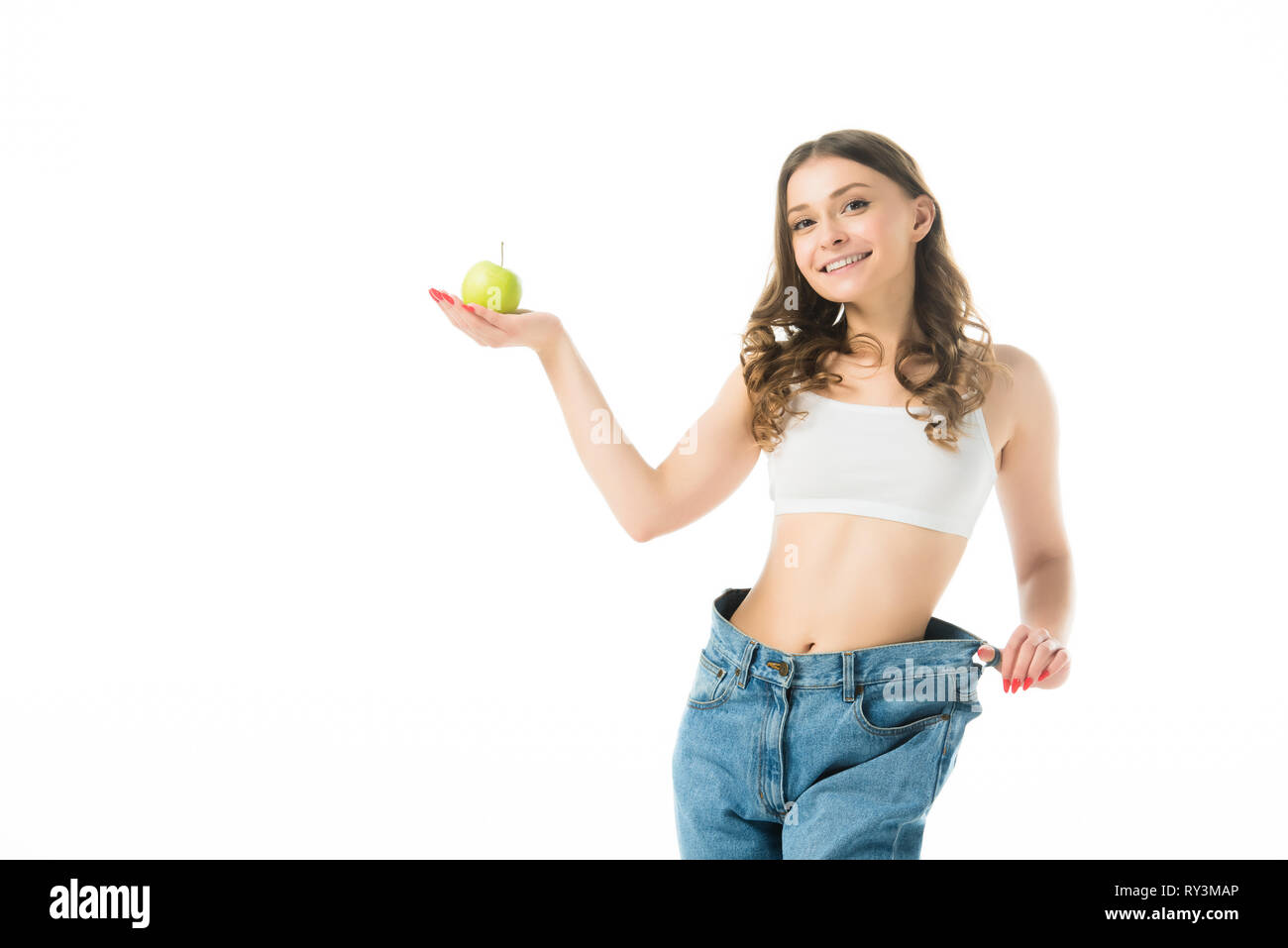 smiling slim young woman in big jeans 