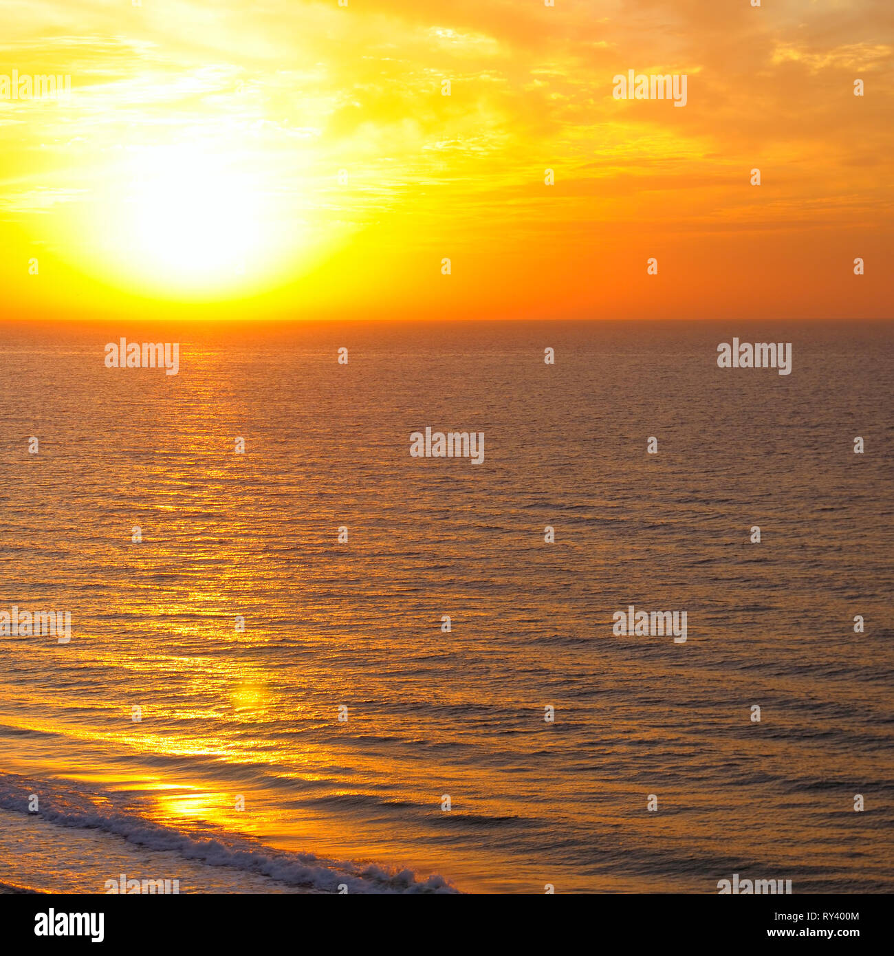 Bright sunrise over the ocean Stock Photo - Alamy