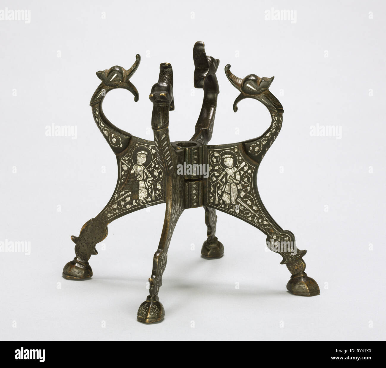 Dragon-headed Stand, 1200s. Northern Iraq or Syria, Zengid or Ayyubid Period, 13th century. Cast brass inlaid with silver; overall: 7.2 x 19.2 cm (2 13/16 x 7 9/16 in Stock Photo