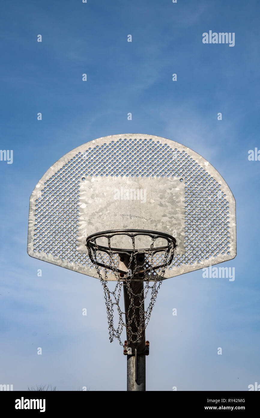 Metallic basketball board and hoop with blue sky in the background Stock Photo Alamy
