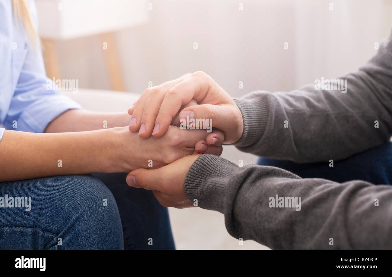 Psychiatrist councelling his patient hands during therapy Stock Photo