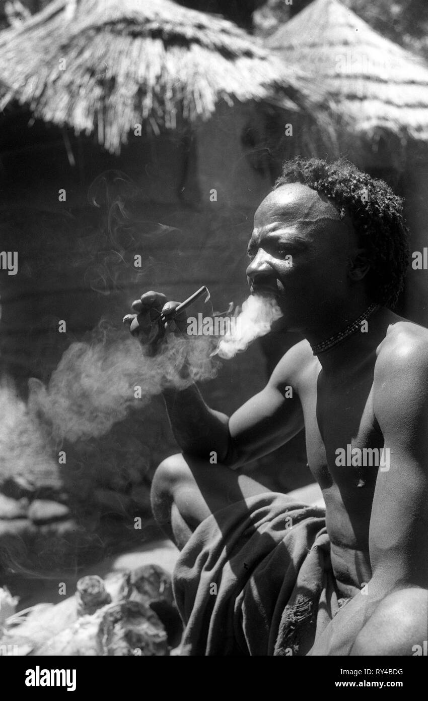 African native man smoking pipe 1949 Stock Photo
